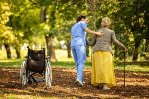 Family member and older resident review care notes together at a kitchen table.